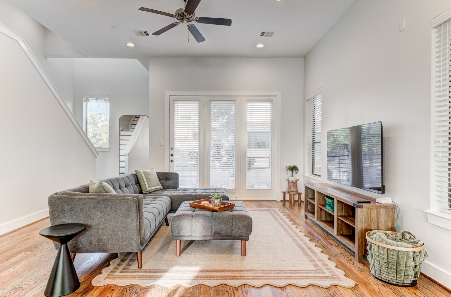 Living room with sectional sofa, ottoman, and French doors