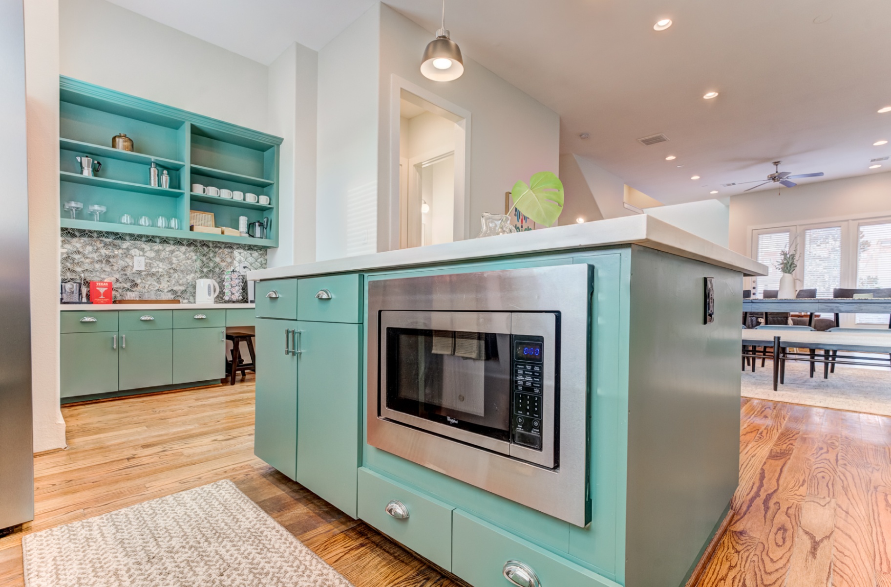 Teal kitchen island with built-in microwave and coffee bar nook