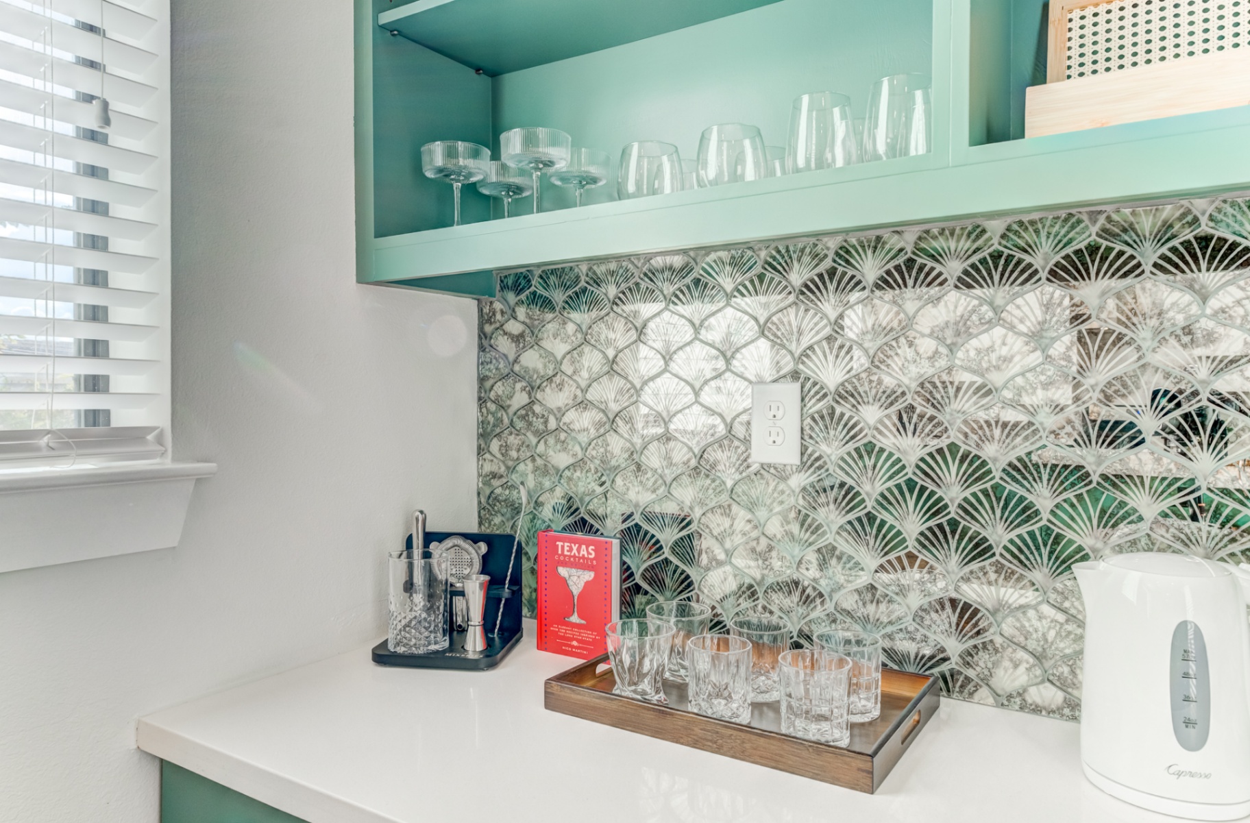 Bar shelf with glassware and patterned backsplash