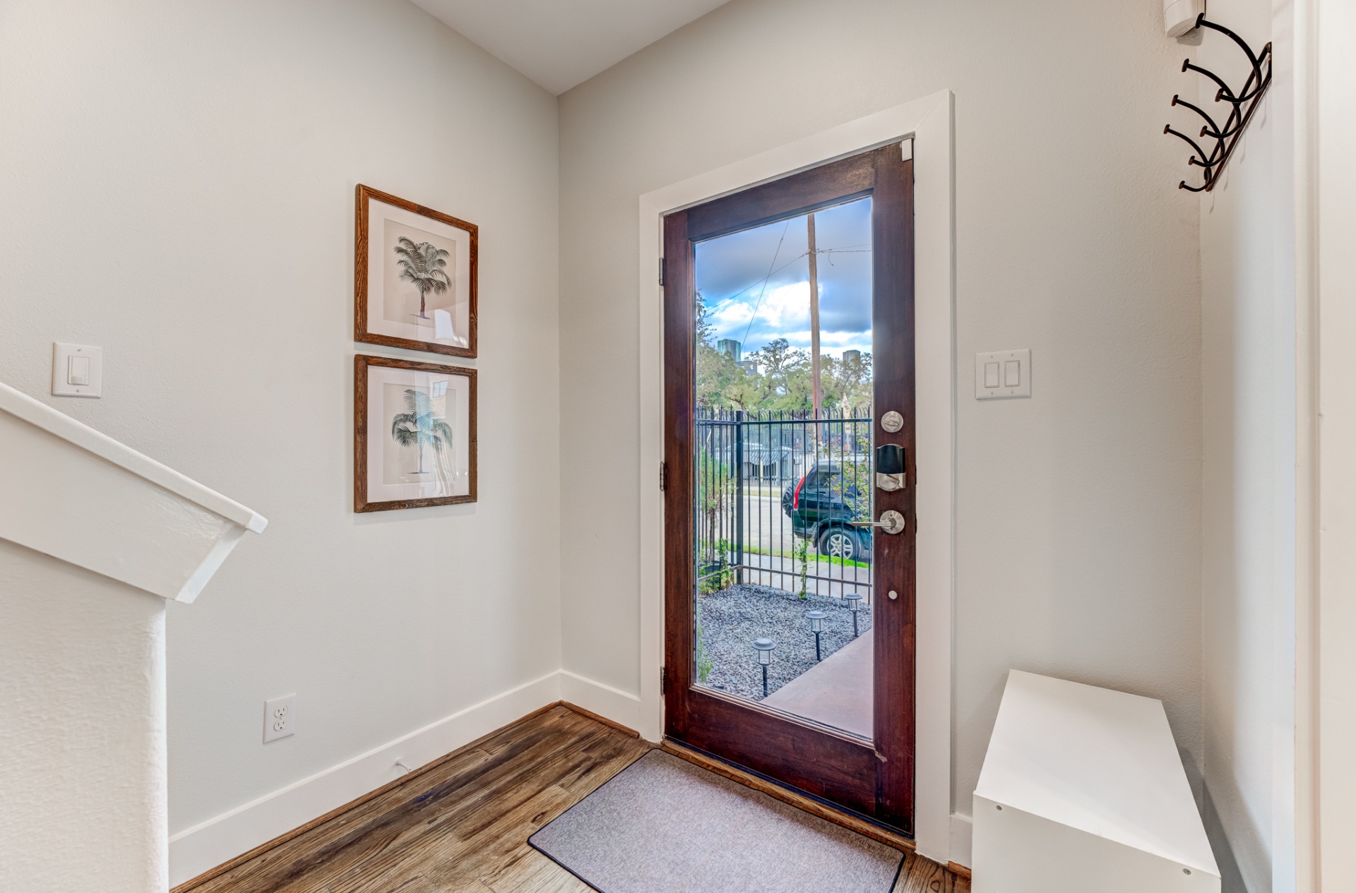 Sunlit entry with framed botanical prints