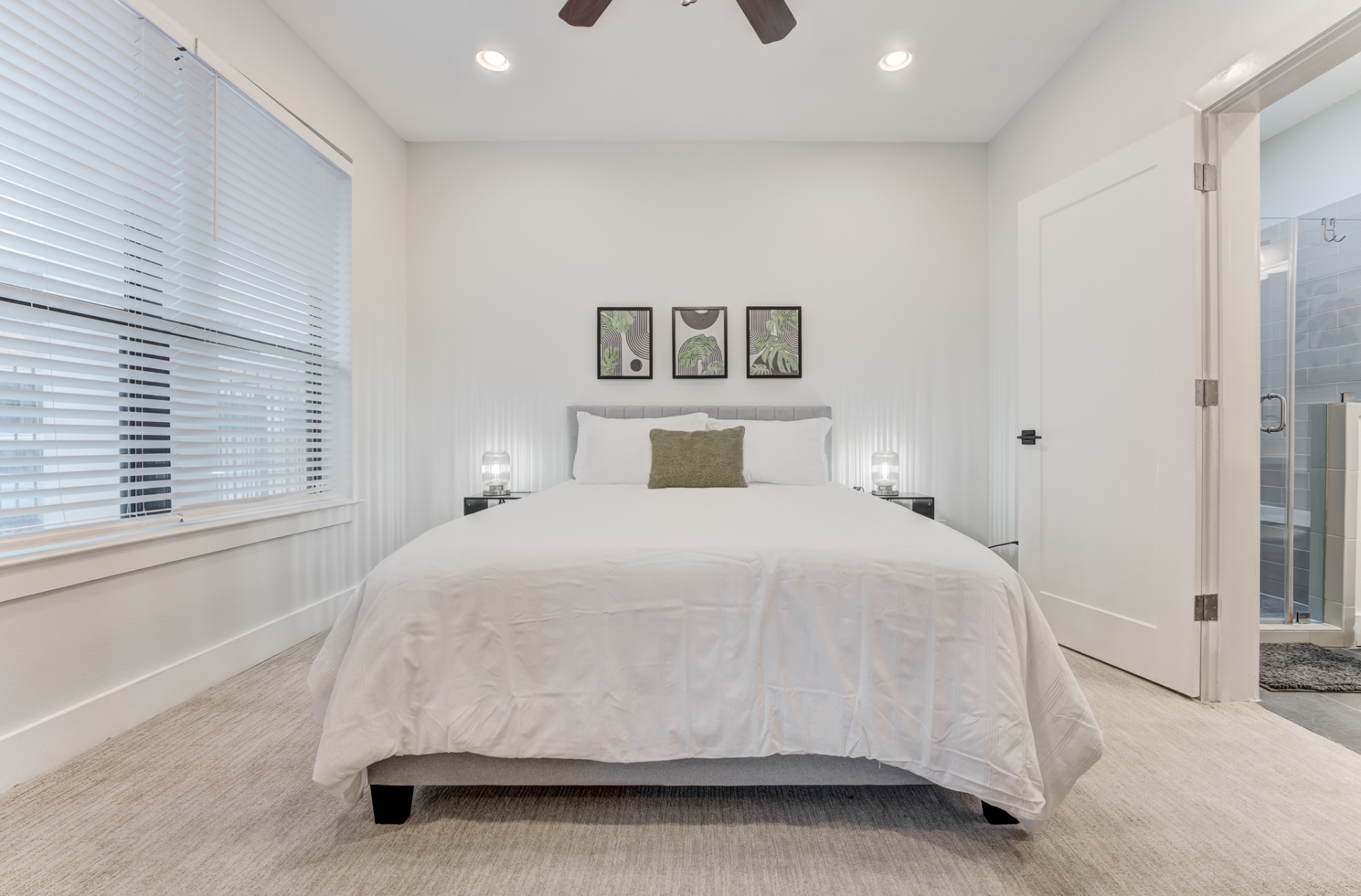 First-floor bedroom featuring a queen bed and dedicated workspace with ensuite bathroom